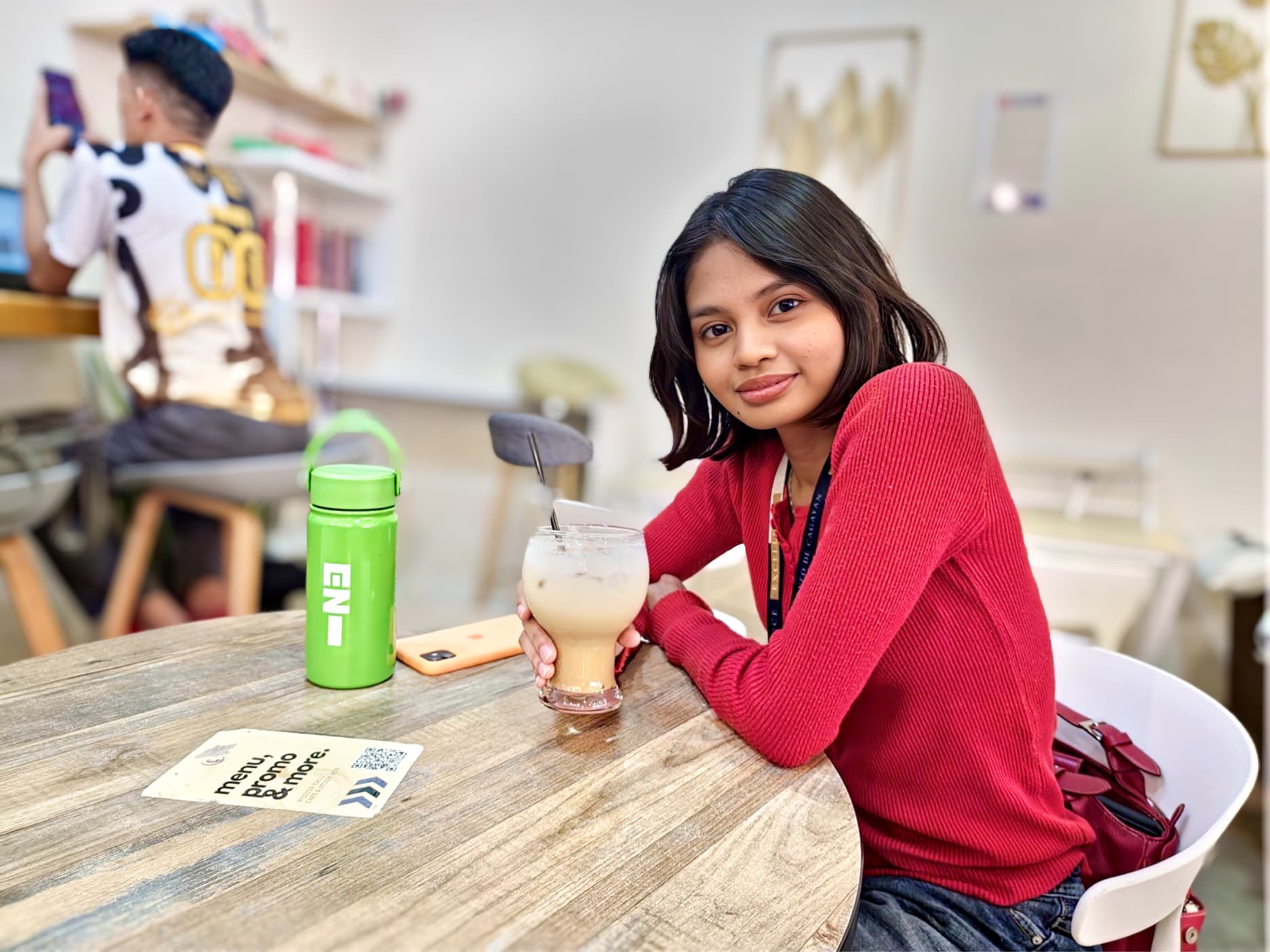 Customer enjoying a drink at WeeCup Call Cafe